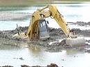 Excavator in Mud After A Sudden Heavy Rain Excavator in Mud After A Sudden Heavy Rain