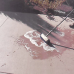 Applying Degreaser To Stains On Colored Concrete